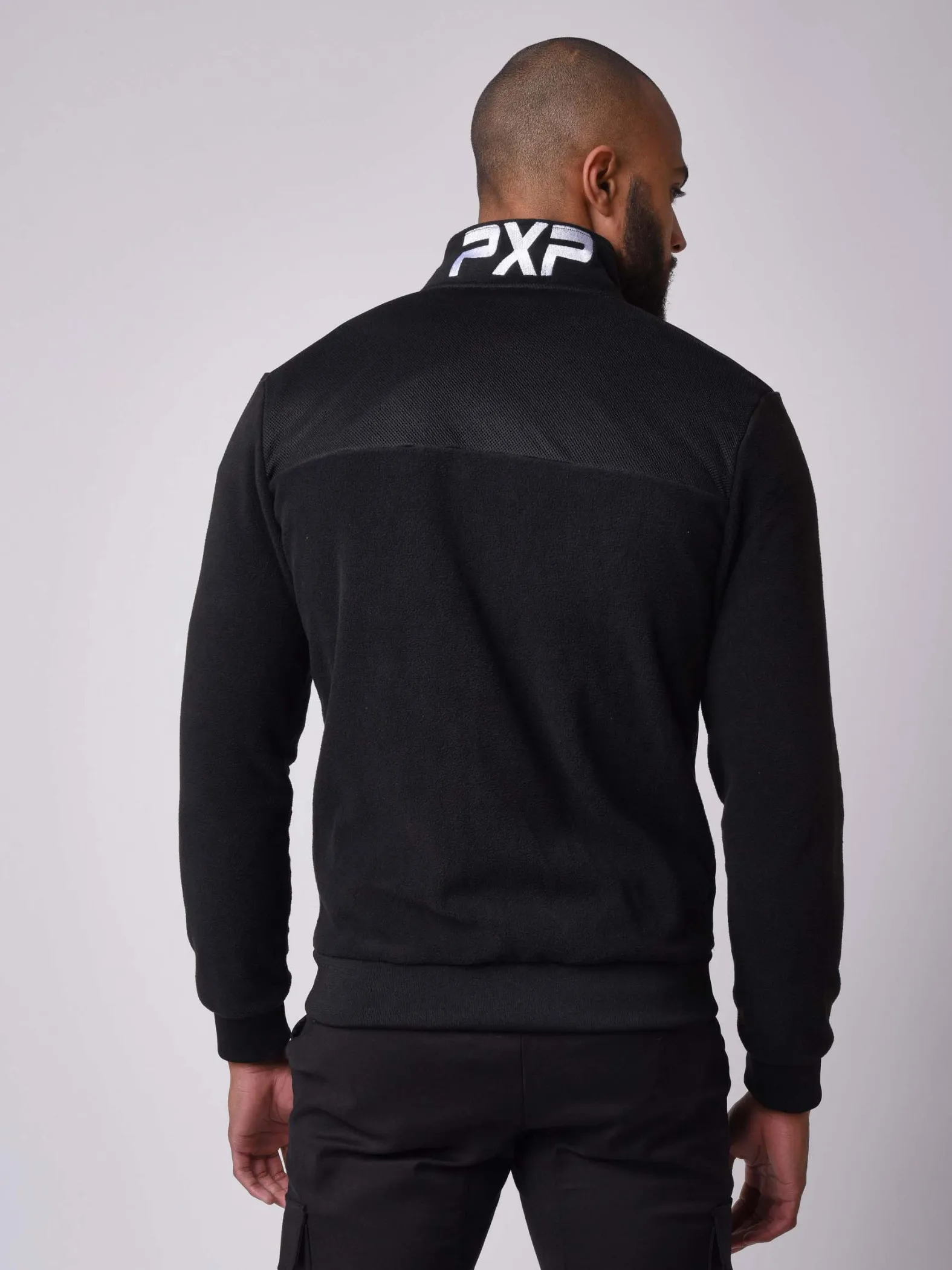 Chaqueta de cuello alto en tejido polar y malla
